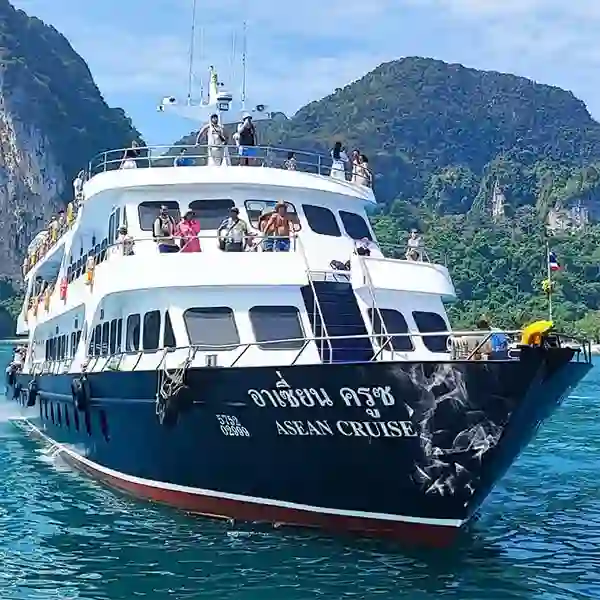Passengers on the open deck of a large standard ferry operating from Phuket to Koh Phi Phi